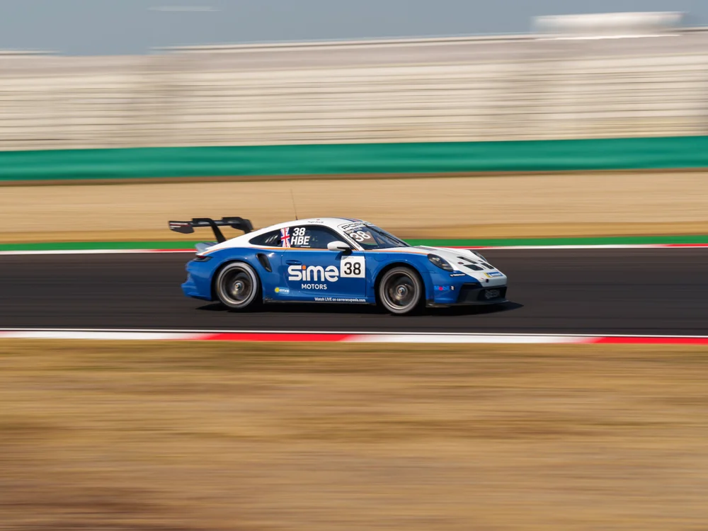Porsche 911 GT3 Cup car driven by Hugo Ellis of Sime Motors Racing in motion at Mobility Resort Motegi during the 2025 Porsche Carrera Cup Asia.